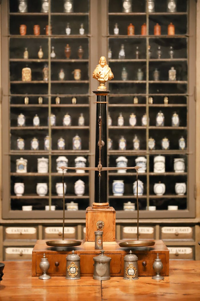 Antique pharmacy scales and apothecary jars in Heidelberg museum.