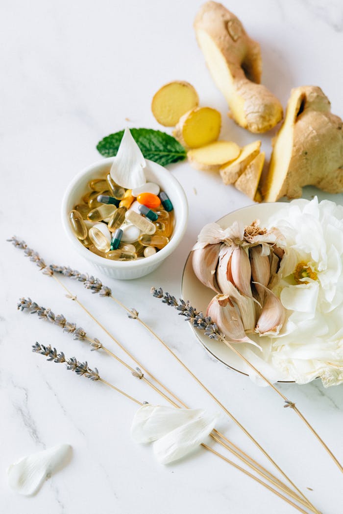 Flat lay of garlic, ginger, and herbal supplements for natural health treatment.